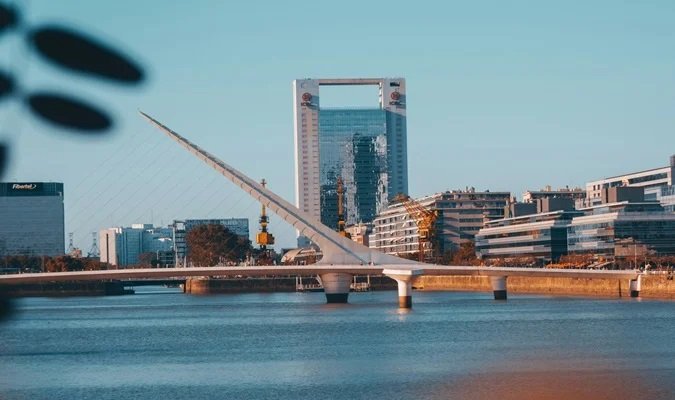 Sit on one of the little benches scattered around Puerto Madero and Admire the view